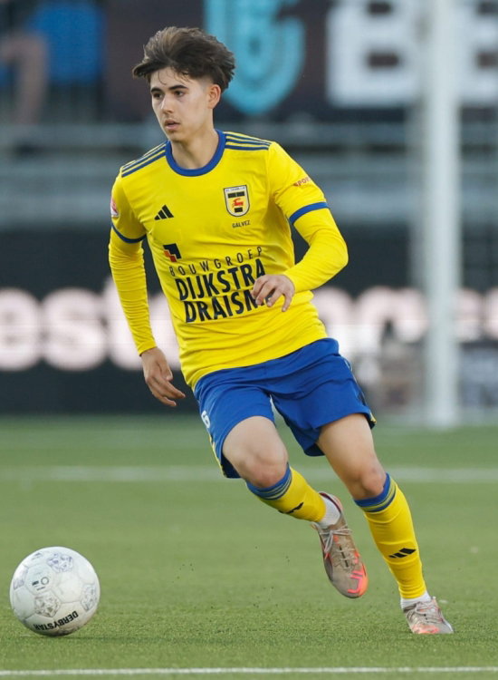 Jeugdspeler in geel aan de bal