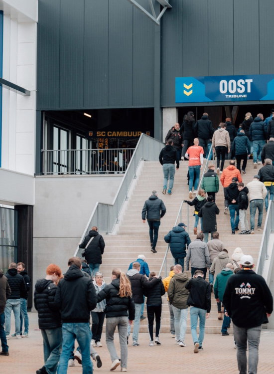 Supporters lopen de trap op naar tribune Oost