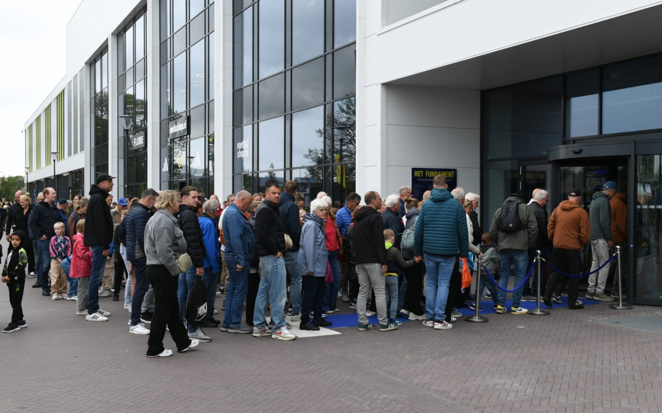 Rij supporters bij de ingang van het stadion