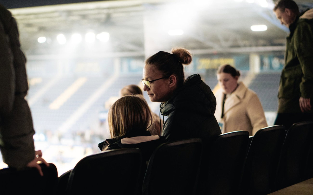 Gasten in de skybox kijken naar de wedstrijd